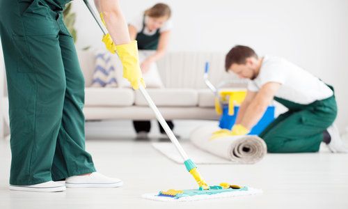 Cleaner cleaning floor using mop
