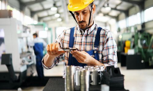 industrial factory employee working in metal manufacturing industry