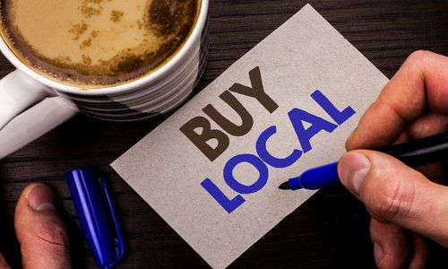 Conceptual hand writing showing Buy Local. Business photo text Buying Purchase Locally Shop Store Market Buy local Retailers written Man Holding Marker on Note Paper Wooden background Coffe