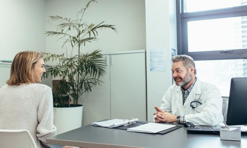 Doctor Talking with Woman in Clinic