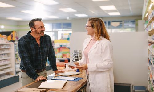 Pharmacist Helping Customer at Pharmacy